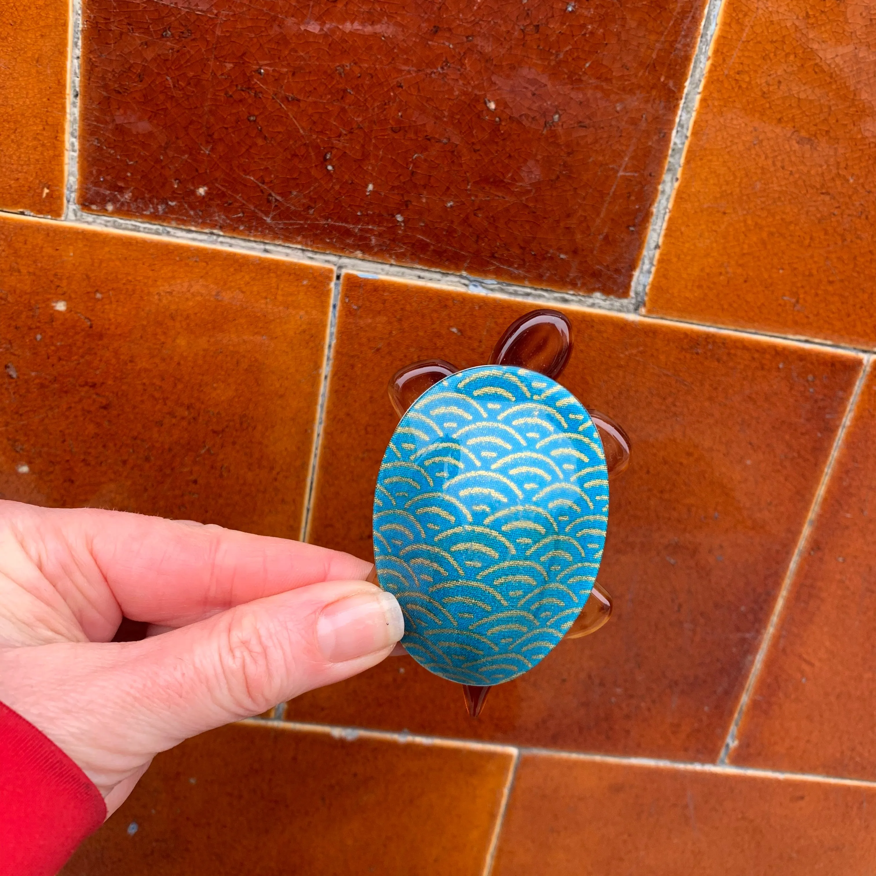 Lea Stein Tortoise in blue and golden pattern.