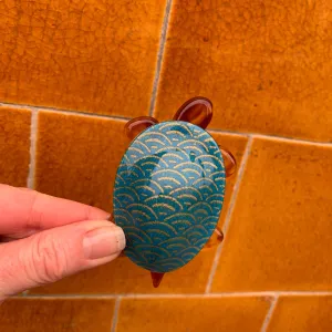Lea Stein Tortoise in blue and golden pattern.